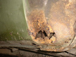 Rust at front end of sill caused by road debris